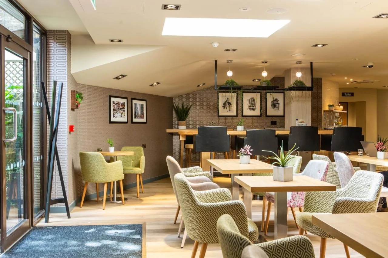 Dining room with tables and chairs at Point A London Liverpool Street